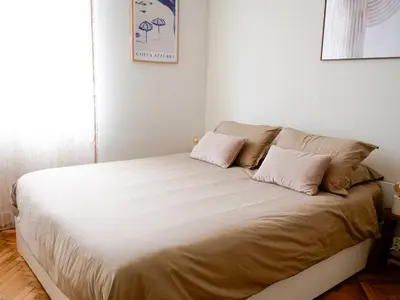 a bed with two pillows on it in a room at Ker Riviera in Nice