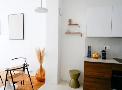a kitchen with white cabinets and a table and chairs at Ker Riviera in Nice