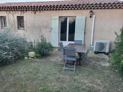 a table and chairs in front of a house at Villa les Gabians in Saint-Laurent-du-Var