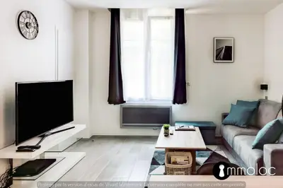 a living room with a couch and a tv at Hyper central studio 2 minutes walk from 