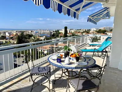 a balcony with a table and chairs on a balcony at VUE DES ANGES AP4238 By Riviera Holiday Homes in Nice