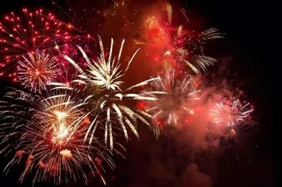 a group of fireworks exploding in the night sky at 3 pièces vue mer et piscine quartier Parc Impérial in Nice