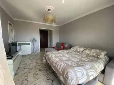 a bedroom with a bed and a flat screen tv at Stylish Modern Beach Studio in Nice