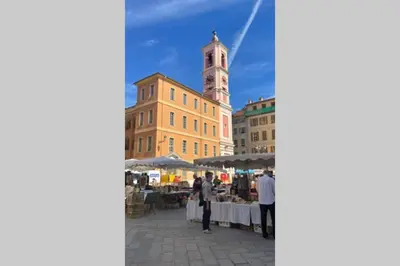 a market in a city with a clock tower at Spacious 3 BR flat Nice center - magnificent view in Nice