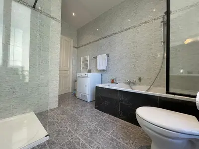 a bathroom with a tub and a toilet and a sink at Spacious 3 BR flat Nice center - magnificent view in Nice