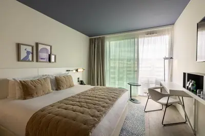 a hotel room with a bed and a window at Hotel Indigo Cagnes-sur-Mer by IHG in Cagnes-sur-Mer