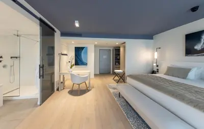 a white bathroom with a tub and a shower at Hotel Indigo Cagnes-sur-Mer by IHG in Cagnes-sur-Mer