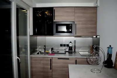 a kitchen with a sink and a microwave at Nice, là côté magique in Nice