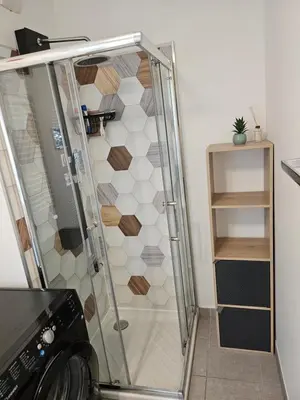 a shower with a glass door in a bathroom at Nice, là côté magique in Nice