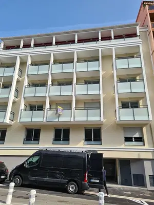 a van parked in a parking lot in front of a building at Nice, là côté magique in Nice