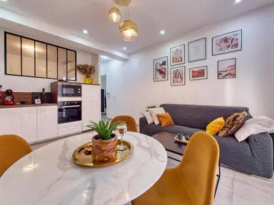 a living room with a table and a couch at City Vibes, Indoor Parking, Breakfast & Air Conditioning in Nice