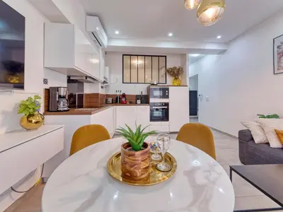 a kitchen and living room with a table and chairs at City Vibes, Indoor Parking, Breakfast & Air Conditioning in Nice
