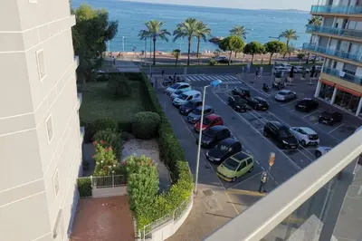 an aerial view of a parking lot next to a building at Appartement 6 personnes face à la mer in Cagnes-sur-Mer