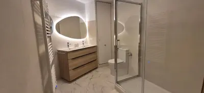 a bathroom with a toilet and a sink and a mirror at Appartement 6 personnes face à la mer in Cagnes-sur-Mer