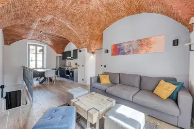 a living room with a couch and a table at Superbe Appartement Au Coeur du Vieux Nice ! in Nice