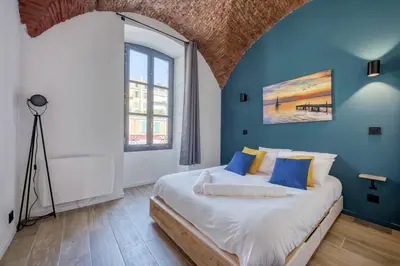 a bedroom with a large bed with blue walls at Superbe Appartement Au Coeur du Vieux Nice ! in Nice