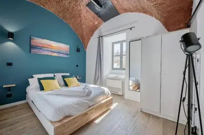 a bedroom with a bed and a blue wall at Superbe Appartement Au Coeur du Vieux Nice ! in Nice