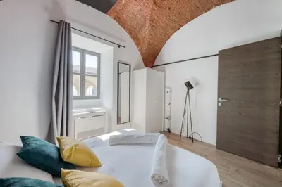 a bedroom with a large white bed and a window at Superbe Appartement Au Coeur du Vieux Nice ! in Nice