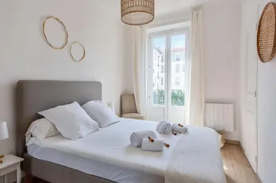 a bedroom with a bed with two stuffed animals on it at Appartement Pertinax - Welkeys in Nice