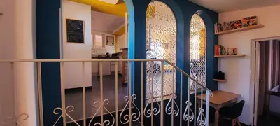 a hallway with a staircase with two stained glass windows at Maison Casa Milesa - Calme, Spa privatif sur demande, Parking securisé, à 12 min des plages in Nice