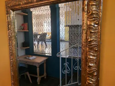 a mirror reflection of a room with a table and a window at Maison Casa Milesa - Calme, Spa privatif sur demande, Parking securisé, à 12 min des plages in Nice
