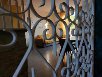 a view of a living room through a iron gate at Maison Casa Milesa - Calme, Spa privatif sur demande, Parking securisé, à 12 min des plages in Nice
