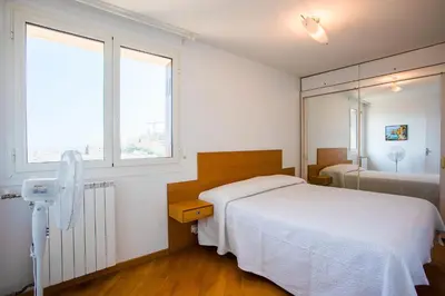 a bedroom with a white bed and a mirror at Passy Azur AP4242 by Riviera Holiday Homes in Nice