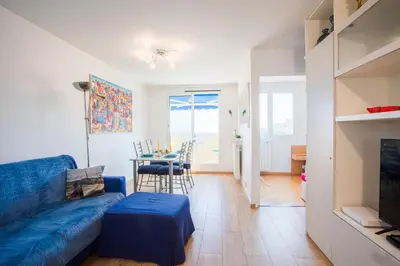 a living room with a blue couch and a table at Passy Azur AP4242 by Riviera Holiday Homes in Nice