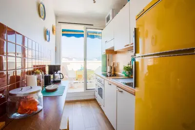 a kitchen with a yellow refrigerator and a counter at Passy Azur AP4242 by Riviera Holiday Homes in Nice