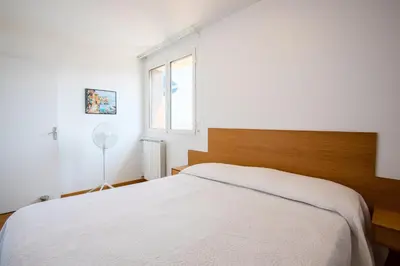 a bedroom with a white bed and a window at Passy Azur AP4242 by Riviera Holiday Homes in Nice