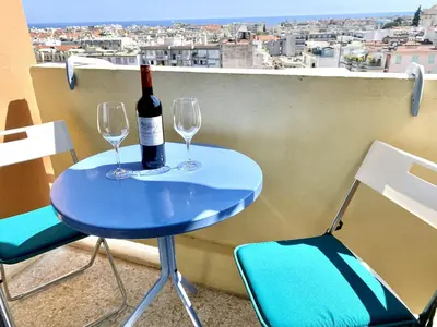 a blue table with two glasses and a bottle of wine at Passy Azur AP4242 by Riviera Holiday Homes in Nice