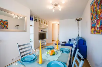 a dining room with a blue table and blue chairs at Passy Azur AP4242 by Riviera Holiday Homes in Nice