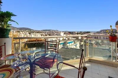 a balcony with a view of a city at La Coquette - Sea View - Parking - AC - Pool in Nice