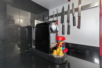 a kitchen counter with utensils on a wall at La Coquette - Sea View - Parking - AC - Pool in Nice