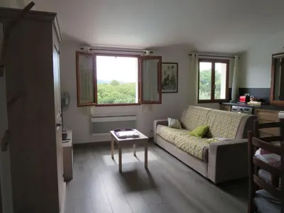 a living room with a couch and a table at 2P entre mer et montagne in Gattières
