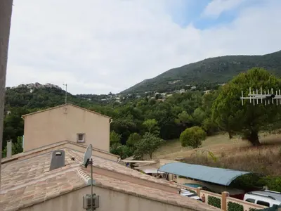 a view of a house with mountains in the background at 2P entre mer et montagne in Gattières