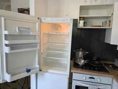 a refrigerator with its door open in a kitchen at 2 spacious bedrooms near Riquier station! in Nice