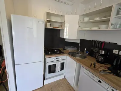 a kitchen with a white refrigerator and a sink at 2 spacious bedrooms near Riquier station! in Nice