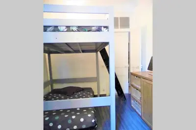 a bunk bed in a room with a desk at 2 spacious bedrooms near Riquier station! in Nice