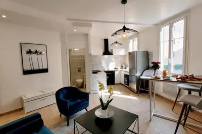 a living room and kitchen with a blue chair and a table at Ze Perfect Place - Confortable appartement 2 CHB - Asc - Port - Garibaldi in Nice
