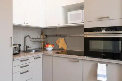 a kitchen with white cabinets and a sink at 