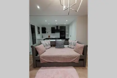 a living room with a couch with pillows at Nid d'amour baignoire/jacuzzi in Nice