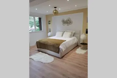 a bedroom with a large white bed with white pillows at Nid d'amour baignoire/jacuzzi in Nice