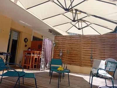 a living room with chairs and a wooden wall at NICE- GAIRAUT - JARDIN PRIVE- GRAND F1 LUMINEUX-Piscine Collective in Nice