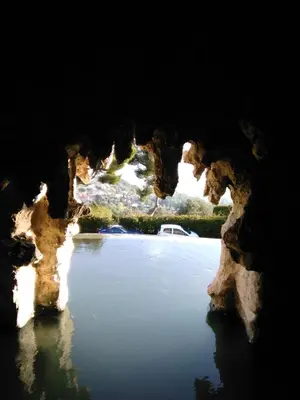 a view from inside a cave of a body of water at NICE- GAIRAUT - JARDIN PRIVE- GRAND F1 LUMINEUX-Piscine Collective in Nice
