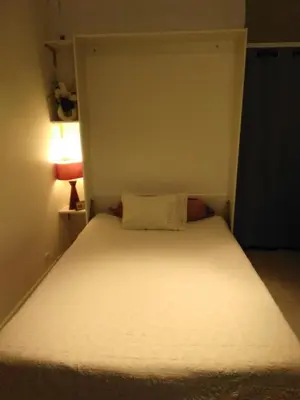 a small bed in a small room with a white mattress at NICE- GAIRAUT - JARDIN PRIVE- GRAND F1 LUMINEUX-Piscine Collective in Nice