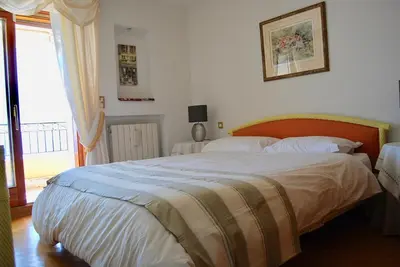 a bedroom with a large bed and a window at Stunning Penthouse with panoramic views of Eze Village and the French Riviera in Èze