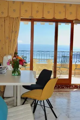 a dining room with a view of the ocean at Stunning Penthouse with panoramic views of Eze Village and the French Riviera in Èze