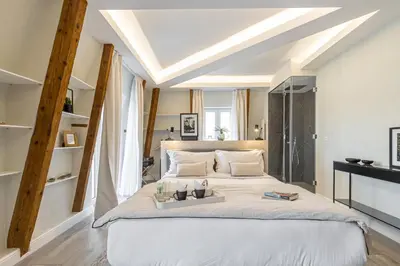 a bedroom with a large bed with a tray on it at Le Dortoir Boutique Suites in Nice