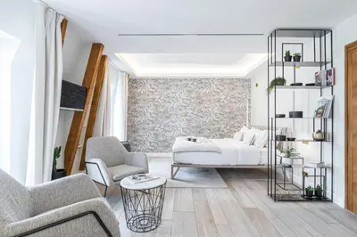 a living room with a bed and two chairs at Le Dortoir Boutique Suites in Nice